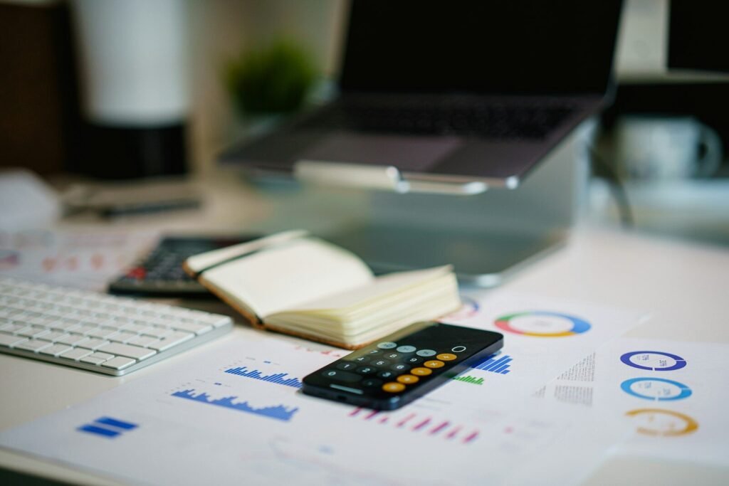 office desk with smartphone and financial charts